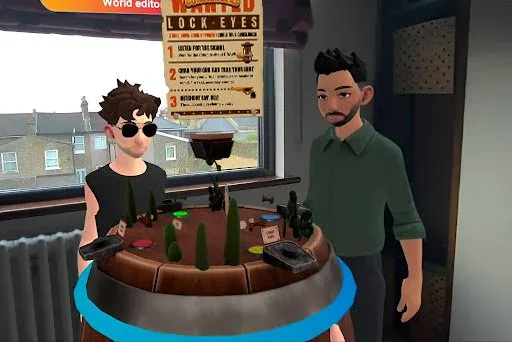 Two avatars standing in a real room beside a barrel-shaped tabletop arena