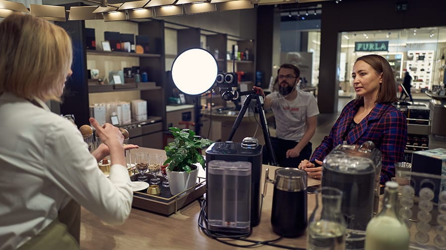 Behind the scenes: the VR180 camera rig filming a conversation at the boutique counter